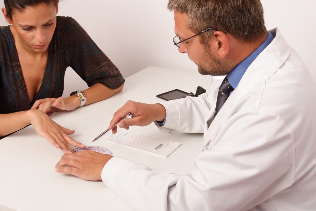 Doctor and patient going over papers in office