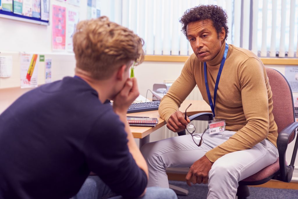 Young man in office with counselor