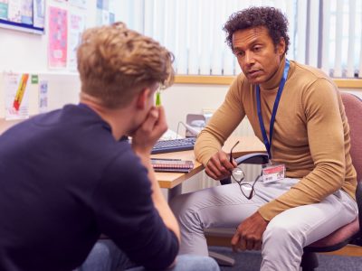 Young man in office with counselor