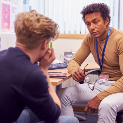 Young man in office with counselor