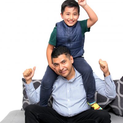 Latino dad plays with his son with autism